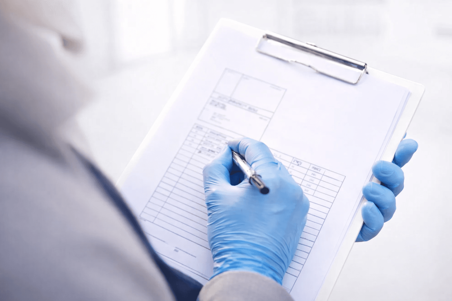 Pest control technician inspecting a property before treatment